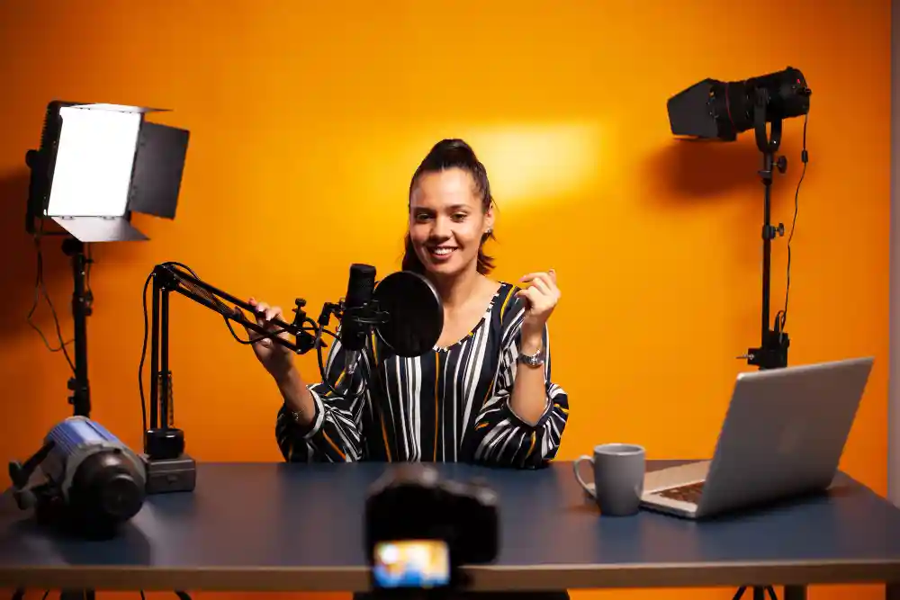 Presenter in a professional studio with production lights and camera equipment